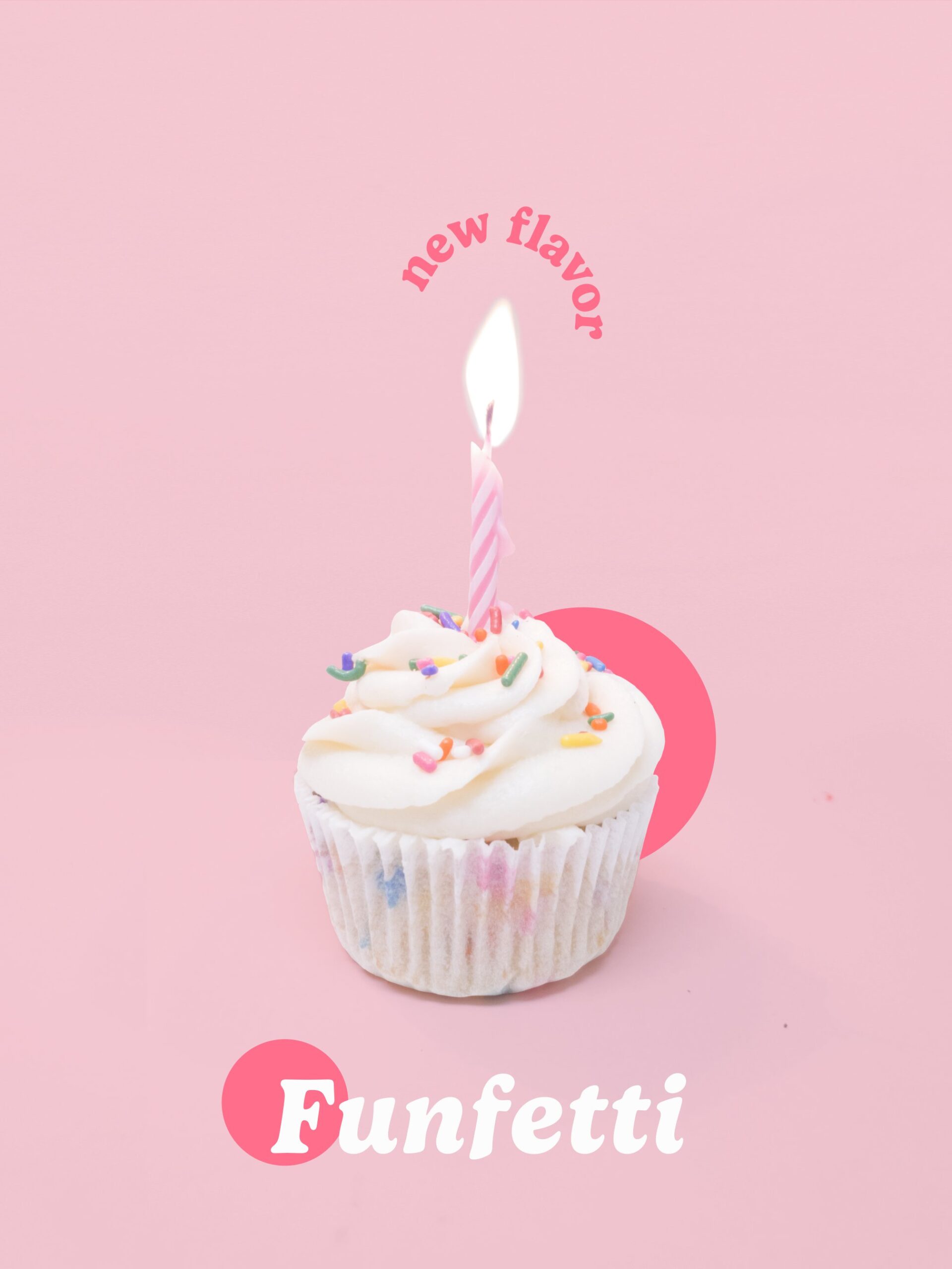 Photograph of a funfetti cupcake with rainbow sprinkles and a lit pink and white striped candle on a light pink background